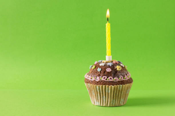 istock homemade muffin, cupcake with candle on a green background 1312001486
