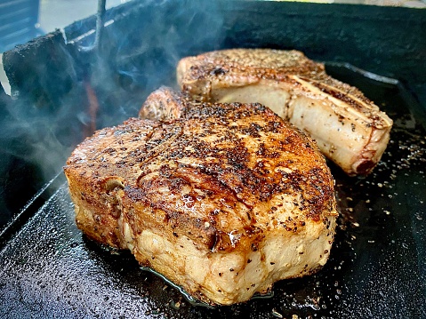 Two extra thick pork chops grilled and seared.