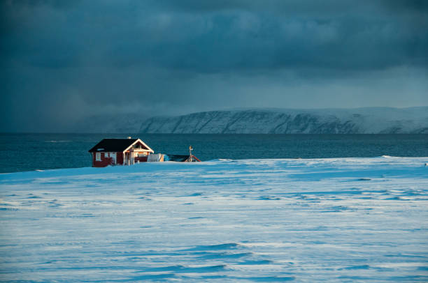 On the road to the North Cape, a solitary house in the winter landscape of the Porsangerfjorden on the Barents Sea