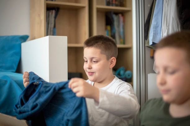 istock Children sorting clothes from their closet for donation 1312009357