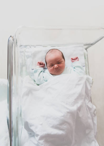 istock Newborn baby is sleeping in small transparent portable plastic bed. 1312011650