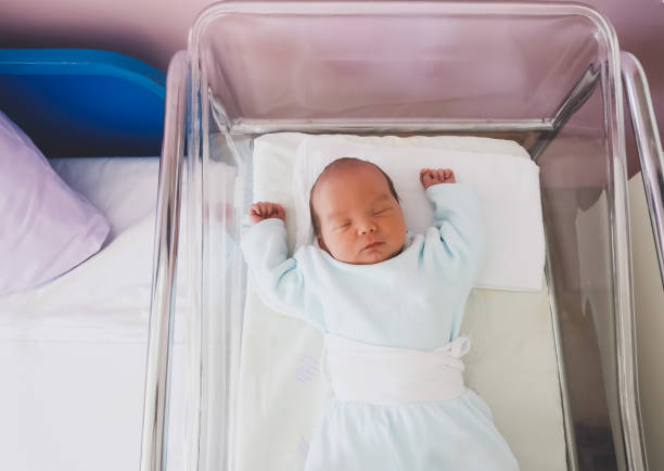 istock Newborn baby is sleeping in small transparent portable plastic bed. 1312011661
