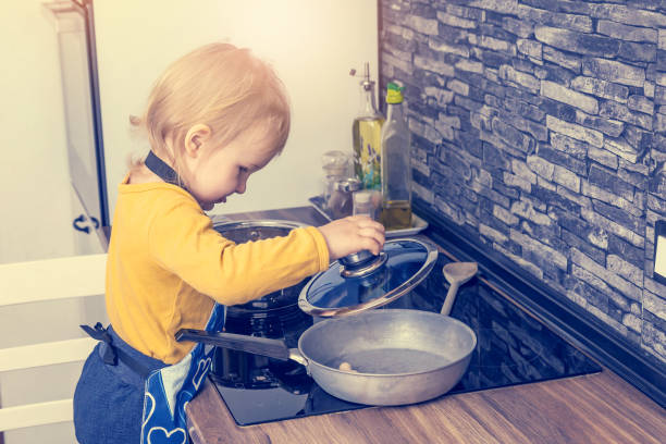 istock Cute little boy is cooking in the kitchen. 1312013660