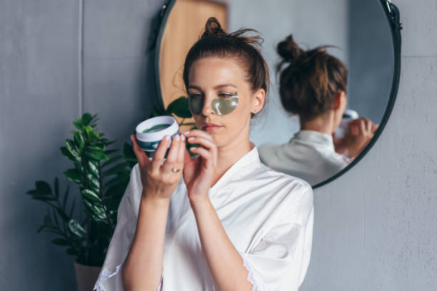 Woman studies the instructions for using eye patches.