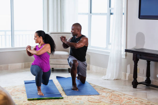 istock Couple at home exercising together, doing lunges 1312017964