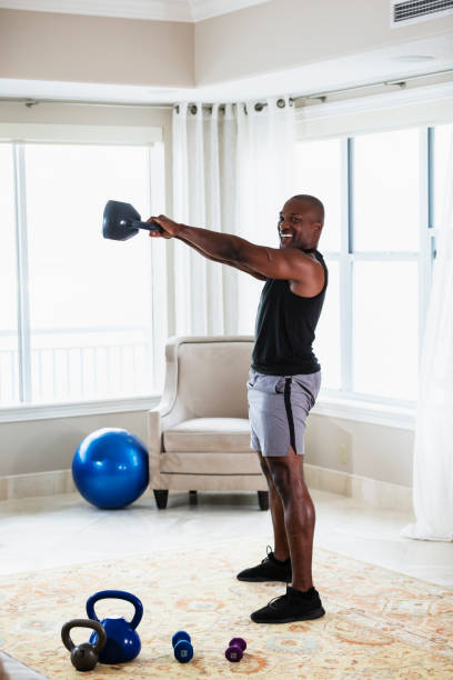 istock African-American man exercising at home with kettlebells 1312017965