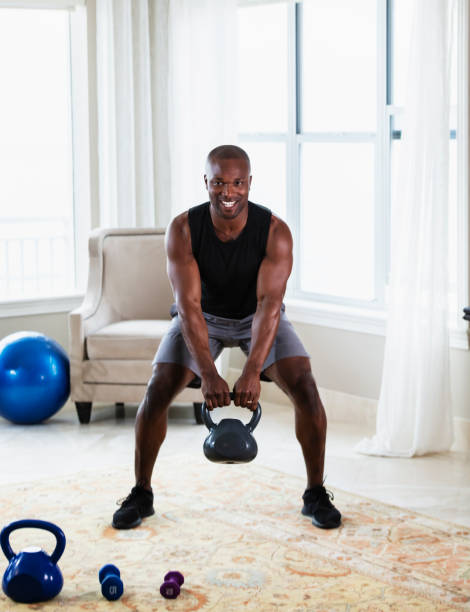 istock African-American man exercising at home with kettlebells 1312018531