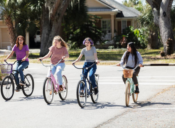 istock Four multi-ethnic tween girls riding bicycles 1312018752