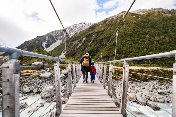 istock Mother and son crossing a floating bridge. 1312020220
