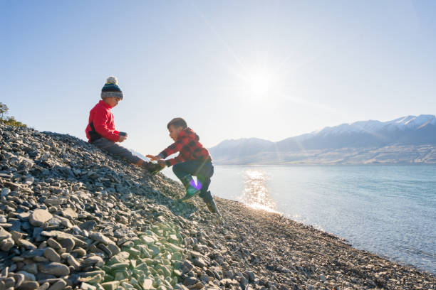 istock Two child climbing on a small stony hill. 1312020266