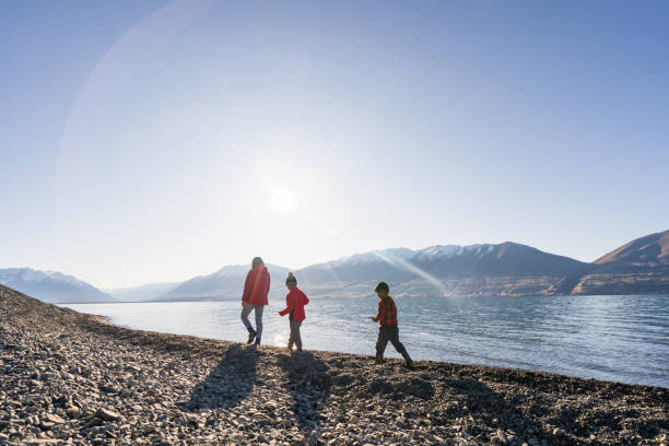 Walking along the coastline and enjoying. Family with two child enjoying at beach at weekend. Walking stock pictures, royalty-free photos & images