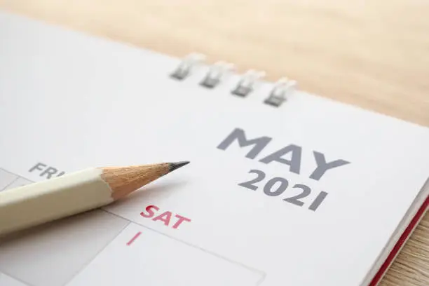Photo of May month on 2021 calendar page with pencil business planning appointment meeting concept