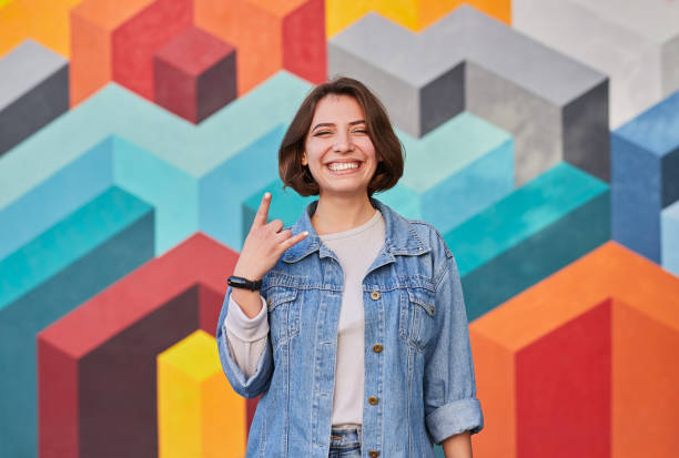 istock Happy woman showing horns gesture 1312022167