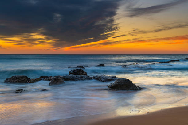 istock Sunrise at the beach with high cloud 1312023365