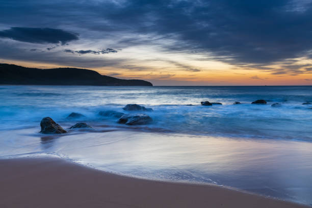 istock Sunrise at the beach with high cloud 1312023625