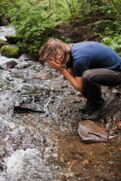 istock Hiker in the Pacific Northwest Splashing Water in Face 1312024604