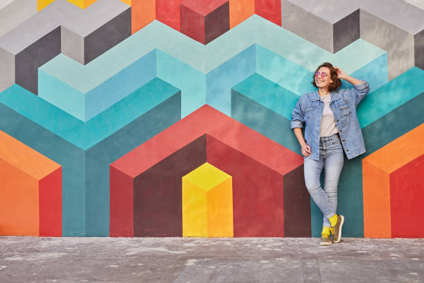 istock Young woman leaning on colorful wall 1312035178