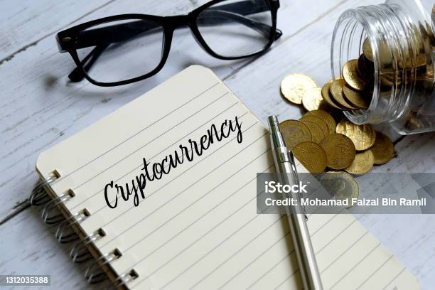 Sunglassesjar Of Coinspen And Notebook Written With Cryptocurrency On White Wooden Background Stock Photo - Download Image Now