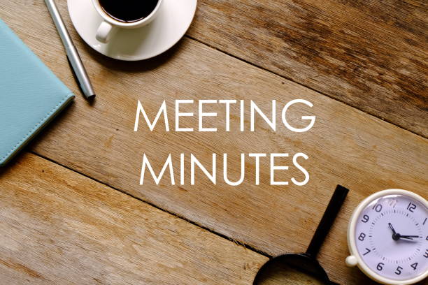 top view of a cup of coffee,notebook,pen,magnifying glass and clock on wooden background written with 'meeting minutes'. - minute hand fotos imagens e fotografias de stock