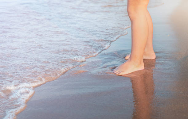 istock Child's feet on beach 1312038026