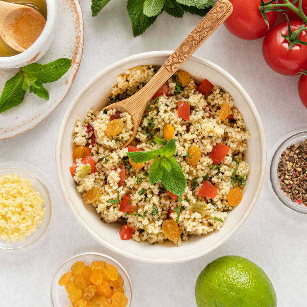 Close-up of a tabbouleh dish Close-up of a tabbouleh dish with surrounding ingredients couscous stock pictures, royalty-free photos & images