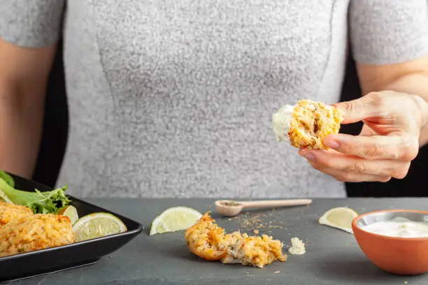 Photo of famous maryland crab cakes with side dishes and dipping sauce