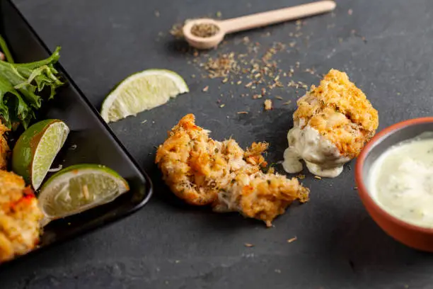 Photo of famous maryland crab cakes with side dishes and dipping sauce