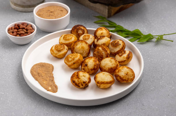istock Suji appe or appam served on a appam pan with peanuts and tamarind chutney 1312054670