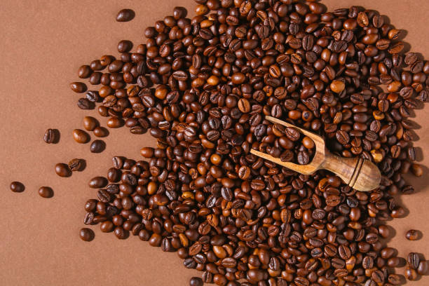 istock Roasted brown coffee beans on a brown background. 1312057207