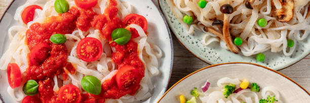 istock Konjac pasta panorama. Fettuccine with various vegetables and sauces 1312058272