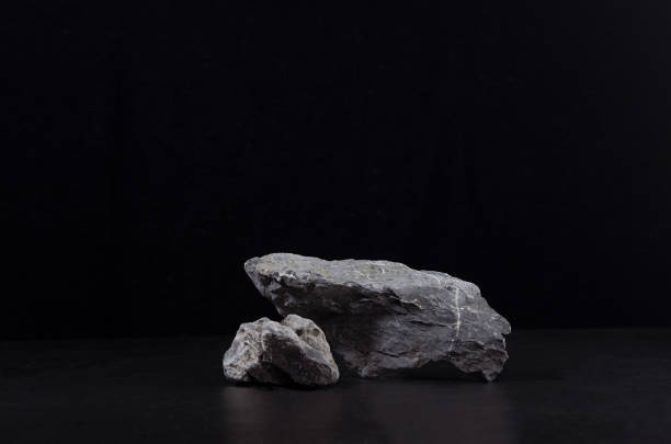 istock Stone podium for showing packaging and product on dark black background, copy space. 1312058722