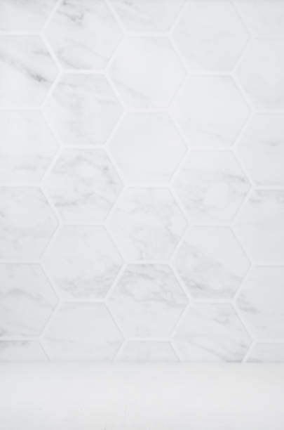 istock Light white grey marble hexagon tile wall with white wood board as floor, empty interior for presentation, display, design, vertical. 1312058723