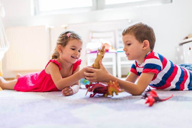 istock Children playing with toy dinosaurs 1312058855