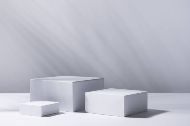 istock White square podiums in sunlight with shadow palm leaf in white space. Tropical showcase for cosmetic products, goods, shoes, bags, watches. 1312059048