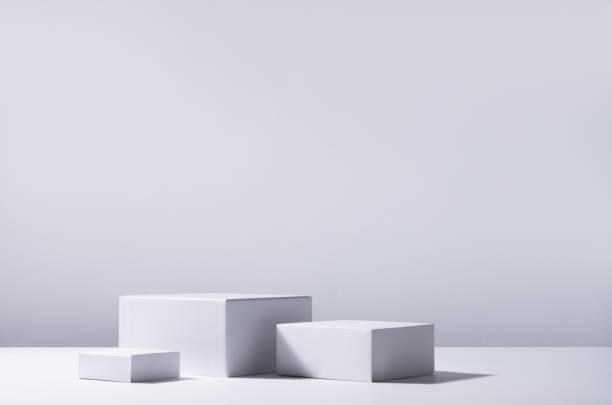 Elegant abstract set of white podiums in sunlight with shadow on white background for product display. Simple modern geometric design. Elegant abstract set of white podiums in sunlight with shadow on white background for product display. Simple modern geometric design. bleachers photos stock pictures, royalty-free photos & images