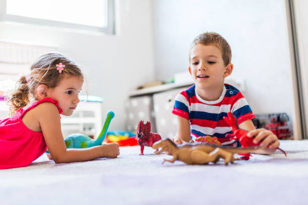 istock Children playing with toy dinosaurs 1312059287