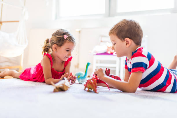 istock Children playing with toy dinosaurs 1312059347