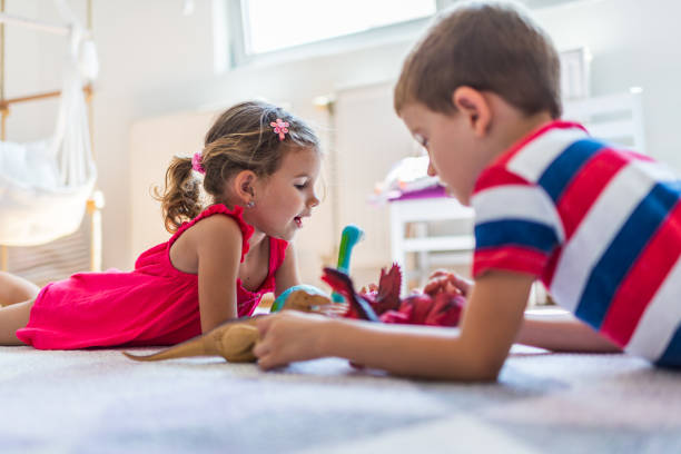 istock Children playing with toy dinosaurs 1312059373