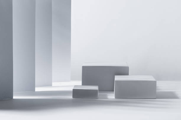 istock White square podiums in sunlight with shadow in white geometric perspective space. Showcase for cosmetic products, goods, shoes, bags, watches. 1312059467