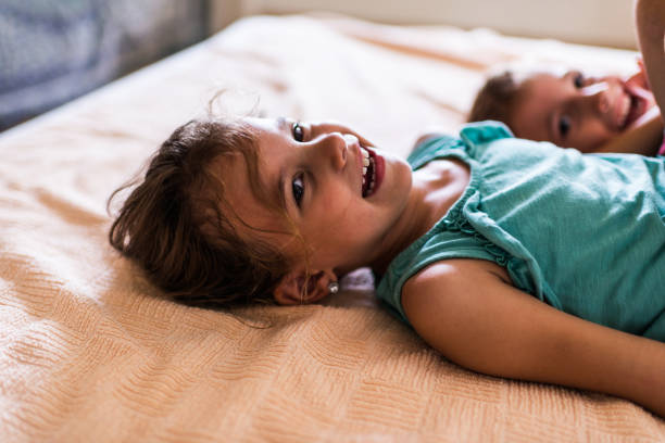 istock Beautiful children playing on the bed 1312060153