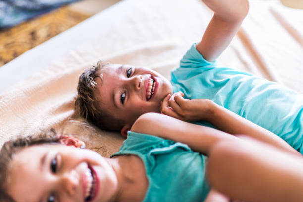 istock Beautiful children playing on the bed 1312060186