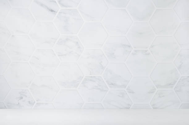 istock Light white grey marble hexagon tile wall with white wood board as floor, empty interior for presentation, display, design. 1312061022