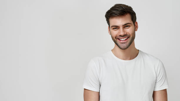 istock Happy man in white t-shirt looking at camera 1312061454