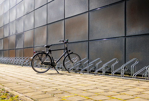 Bicycle parking lot reservation sign which is installed on the parking ceiling structure. Transportation and traffic symbol object photo.