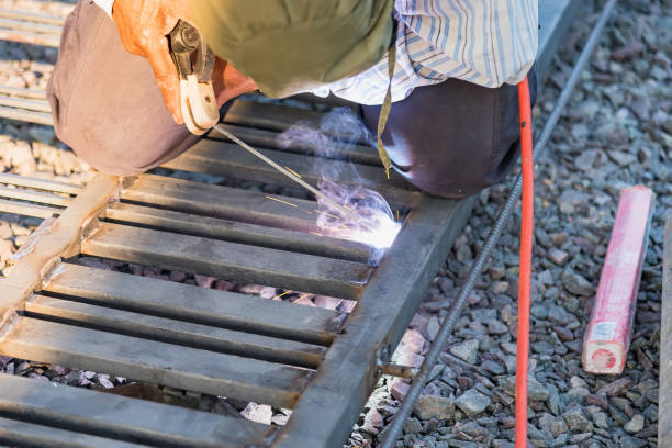 istock Man Welding in Workshop Sparks Metalwork Construction Industrial 1312063465