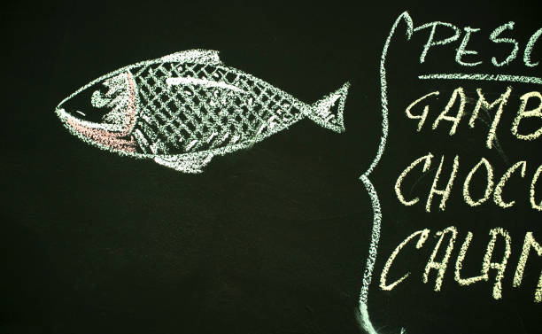 istock Restaurant menu board offering fish with colorful drawings 1312064343
