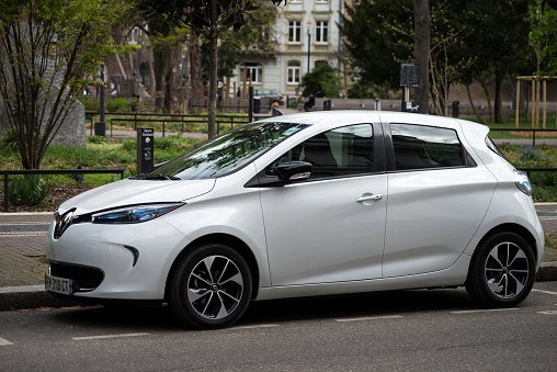 Mulhouse - France - 11 April 2021 - Profile view of white Renault Zoe electric car parked in the street