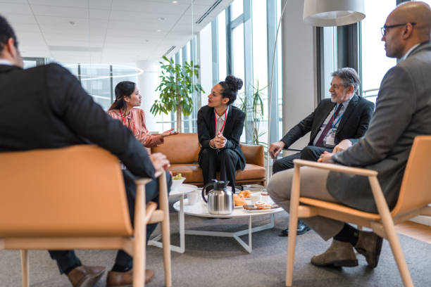 istock Informal Business Meeting in A Modern Office Lobby 1312066292