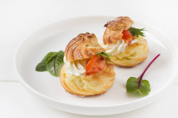 istock Profiterole staffed  with cream cheese and  tomatoes Cheese profiteroles, profiterole buffet 1312066619
