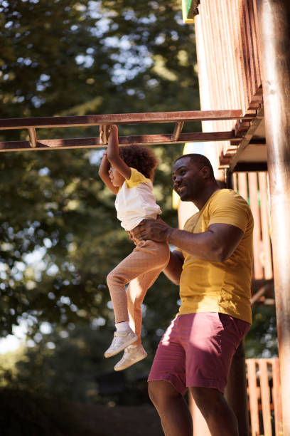 istock African American father and daughter playing together. 1312067005